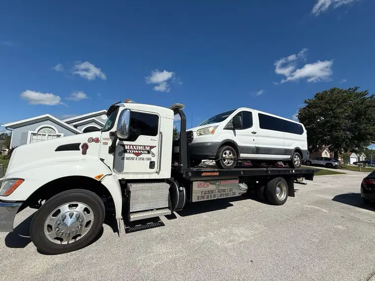 Kenworth carrier loading a van